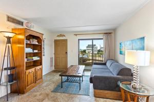 a living room with a couch and a table at DL104 - Dune's Watch in Nags Head