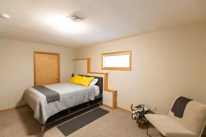 a bedroom with a bed and a chair in it at The Oaks in Lyle