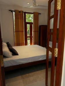a bedroom with a bunk bed and a window at Urban Isle Resort in Ahangama