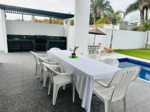 a white table and chairs on a patio at Quinta Frida in Oaxtepec