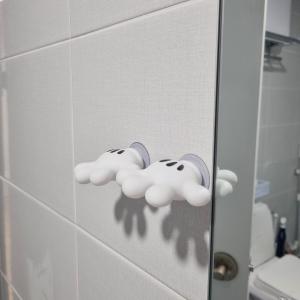 a door with two clouds on the wall of a bathroom at Dear Home in Daegu