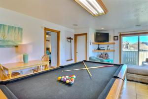 a living room with a pool table and a couch at 7030 - Explorers Beacon in Whalebone
