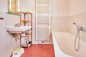 une salle de bain avec une baignoire et un lavabo et une baignoire dans l'établissement Finja, à Fuhlendorf 17 autres photos