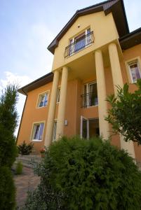 a building with columns and a balcony at OW Delta in Rewal