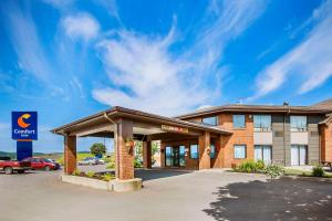 a hotel front of a building with a parking lot at Comfort Inn in Amherst