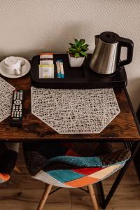a table with a tea kettle on top of it at Pałac pod Bocianim Gniazdem in Runowo +120 photos