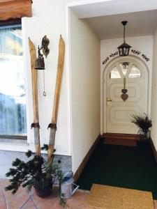 a front door of a building with skis on the wall at Vila Edelweiss Rooms&App Kranjska Gora in Kranjska Gora