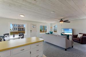 a living room with a couch and a table at 4086 - The Wren's Nest in Kitty Hawk +23 photos