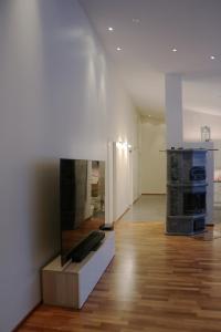 a living room with a fireplace and a wooden floor at Arctic Fox Rovaniemi in Rovaniemi