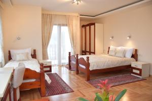 Rúm í herbergi á IN Hotel Zlatar ex Zlatarski Biseri