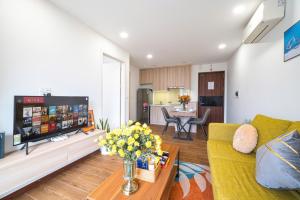 a living room with a couch and a tv at Luxe Paradise Hotel Nguyen Khac Hieu in Hanoi +72 photos