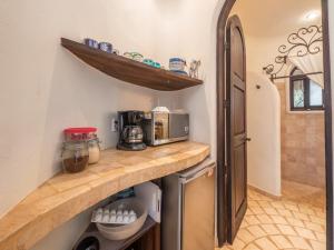 a kitchen with a counter top with a microwave at Casa Hafiz in Sayulita