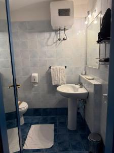 a small bathroom with a sink and a toilet at Luna Convento Copanello B&B in Stalettì