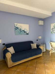 a blue couch sitting in a living room at Luna Convento Copanello B&B in Stalettì