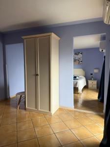 a room with a cupboard and a bedroom at Luna Convento Copanello B&B in Stalettì