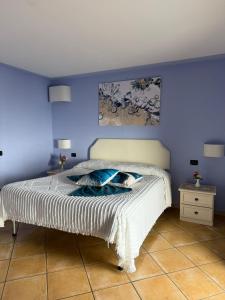 a bedroom with a bed with a blue wall at Luna Convento Copanello B&B in Stalettì +37 photos