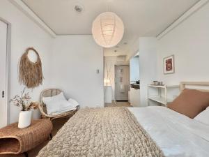 a bedroom with a large bed and a chair at shinjuku yichun hostel in Tokyo