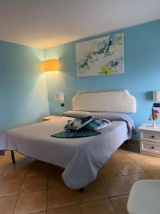 a bedroom with a bed with a towel on it at Luna Convento Copanello B&B in Stalettì
