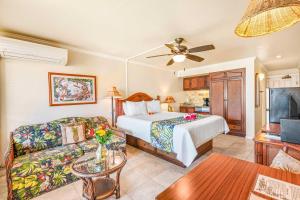 a hotel room with a bed and a couch at Islander on the Beach 343 in Kapaa +47 photos