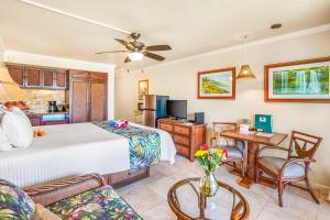 a bedroom with a bed and a living room at Islander on the Beach 343 in Kapaa
