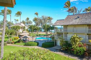 an aerial view of a resort with a pool and palm trees at Islander on the Beach 343 in Kapaa