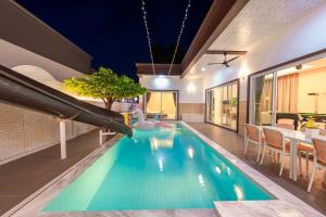 a pool in a house with a slide at Homey House Na Jomtien in Na Jomtien