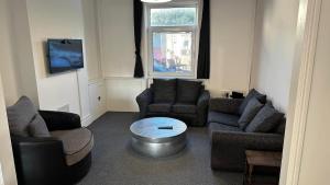 a living room with two couches and a table at Kingsholm House on the Rainbow Street-4 Bedroom-Sleeps 8 in Gloucester