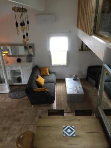a living room with a couch and a table at Villa Mäenma in Le Teich