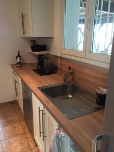 a kitchen with a sink and a counter top at Villa Mäenma in Le Teich +7 photos