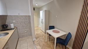 a bathroom with a sink and a table and a shower at King apartment in Novi Sad