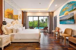 a bedroom with a large bed and a living room at Langco Bay Retreat in Lang Co