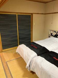 Postel nebo postele na pokoji v ubytování Private Lodging KASE 五所川原