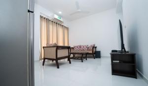a living room with two chairs and a couch at Sea View Fully Furnished Luxury Apartment in Dehiwala