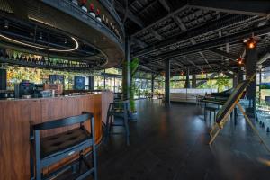 a bar in a restaurant with tables and chairs at Lov Faralya Adults Only in Faralya