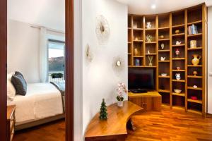a bedroom with a bed and a tv in a room at la vista sul lago in Castel Gandolfo
