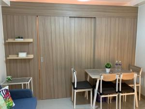 a dining room with a table and chairs at Tropical Sanctuary in Pasay City in Manila