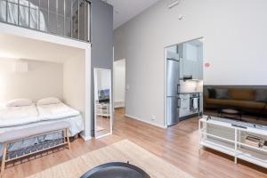 a bedroom with a bed and a large mirror at "Hämeenkatu" - Renovated Loft at the BEST location, Hosted by 2ndhomes in Tampere