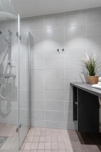 a bathroom with a shower and a sink at "Hämeenkatu" - Renovated Loft at the BEST location, Hosted by 2ndhomes in Tampere