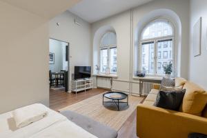 a living room with a couch and a table at "Hämeenkatu" - Renovated Loft at the BEST location, Hosted by 2ndhomes in Tampere