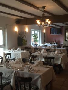 a dining room with tables with white table cloth at Colnbrook Lodge Guest House in Slough