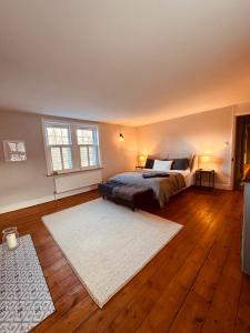 a bedroom with a bed and a white rug at Luxury House sleeps 14 with Secret Bar near Bath in Warminster