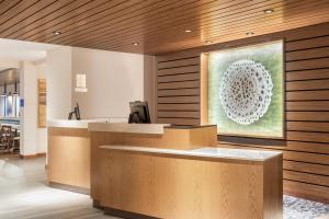 a lobby with a reception desk with a painting on the wall at Fairfield Inn & Suites by Marriott Jasper in Jasper +15 photos