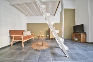 a living room with a ladder and a couch at Le Coquebert - Studio in Reims