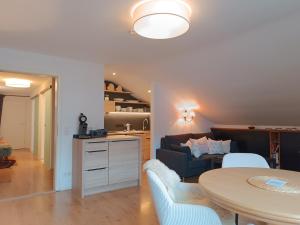 a living room with a couch and a table at 2-Raum FeWo Alina - Hallenbad & Sauna in Fischen