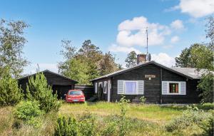 a house with a red car parked in front of it at Kanalhytten in Rømø Kirkeby