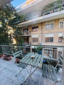 a table and chairs in front of a building at CASA LORY Balduina in Rome