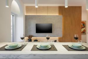 a dining room with a table with glasses of wine at Amara Local Experience in Chania Town
