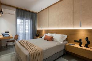 a bedroom with a bed and a desk and a table at Amara Local Experience in Chania Town