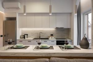 a kitchen with a table with glasses of wine at Amara Local Experience in Chania Town