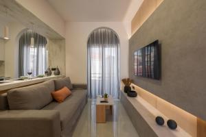 a living room with a couch and a table at Amara Local Experience in Chania Town +37 photos